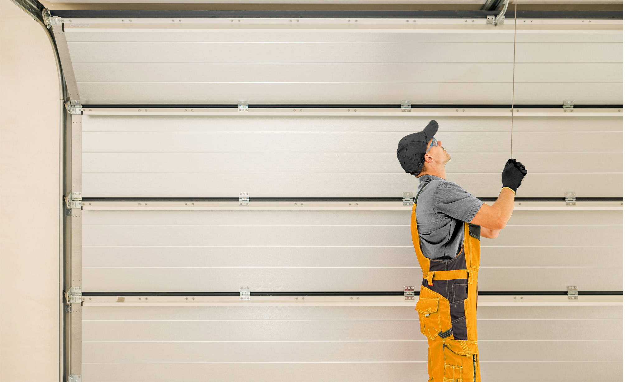 A repairman installing a new garage door